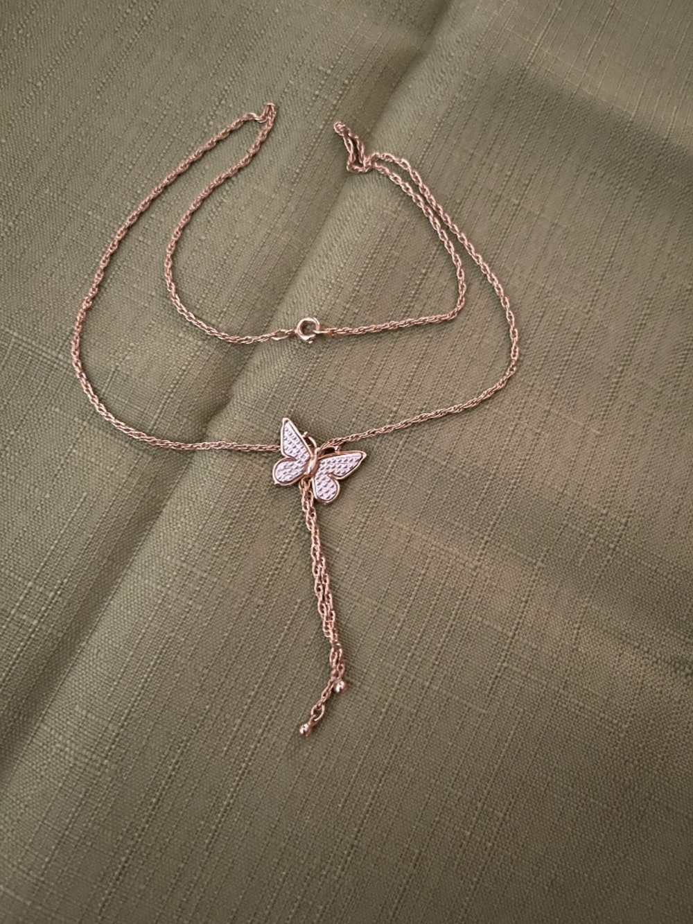 Butterfly on gold tone necklace